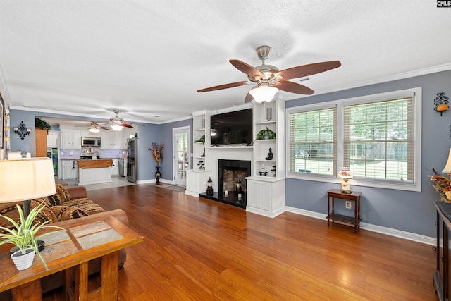 1220 Barnwell Dr, Sumter, SC 29154 - living room with a ceiling fan, a fireplace with raised hearth, wood finished floors, ornamental molding, and a textured ceiling