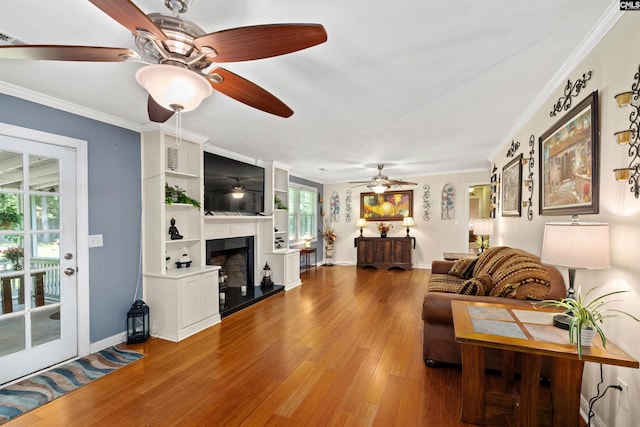1220 Barnwell Dr, Sumter, SC 29154 - living room with a ceiling fan, wood finished floors, a fireplace with raised hearth, and crown molding