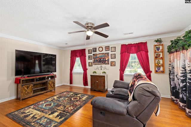 1220 Barnwell Dr, Sumter, SC 29154 - living area featuring a ceiling fan, healthy amount of natural light, a textured ceiling, wood finished floors, and ornamental molding