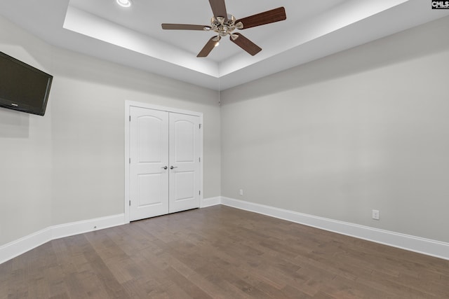 143 Club Ridge Rd, Elgin, SC 29045 - unfurnished bedroom featuring a raised ceiling, dark wood-style floors, a ceiling fan, a closet, and recessed lighting