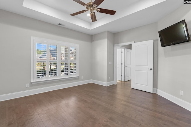 143 Club Ridge Rd, Elgin, SC 29045 - unfurnished bedroom with a tray ceiling, dark wood-style floors, and ceiling fan