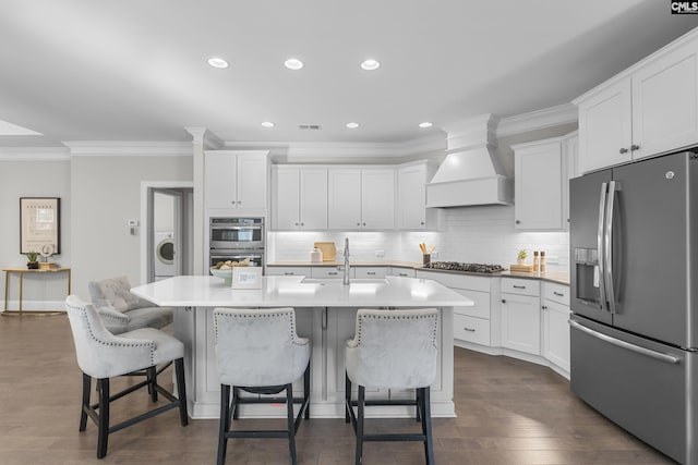 143 Club Ridge Rd, Elgin, SC 29045 - kitchen featuring stainless steel appliances, custom range hood, ornamental molding, white cabinetry, and recessed lighting