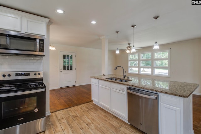 1748 Omarest Dr, Columbia, SC 29210 - kitchen with appliances with stainless steel finishes, healthy amount of natural light, light wood-style flooring, recessed lighting, and crown molding