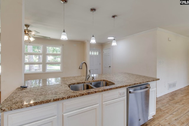 1748 Omarest Dr, Columbia, SC 29210 - kitchen with stainless steel dishwasher, ornamental molding, light stone countertops, white cabinets, and pendant lighting