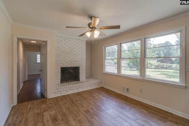1748 Omarest Dr, Columbia, SC 29210 - unfurnished living room featuring crown molding, hardwood / wood-style floors, ceiling fan, and a brick fireplace