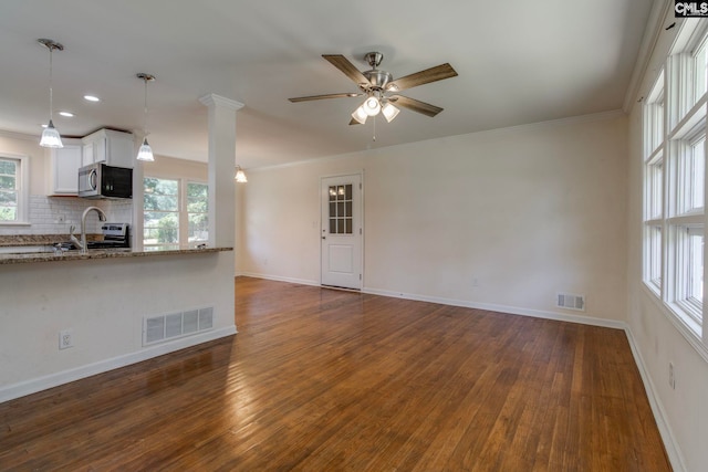 1748 Omarest Dr, Columbia, SC 29210 - unfurnished living room with dark wood-style floors, plenty of natural light, a ceiling fan, ornamental molding, and recessed lighting