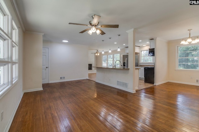 1748 Omarest Dr, Columbia, SC 29210 - unfurnished living room featuring ceiling fan, wood-type flooring, a chandelier, crown molding, and recessed lighting