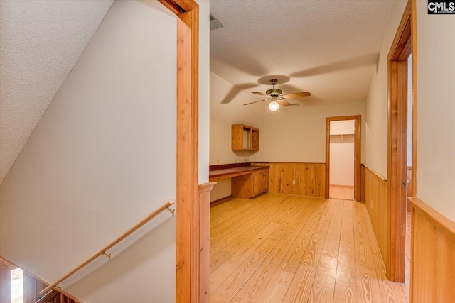 518 Pioneer Shores Rd, Prosperity, SC 29127 - interior space with a textured ceiling, light wood-type flooring, a wainscoted wall, wood walls, and an upstairs landing