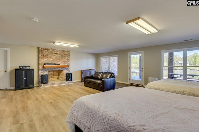 518 Pioneer Shores Rd, Prosperity, SC 29127 - bedroom with access to outside, light wood-style flooring, and a brick fireplace