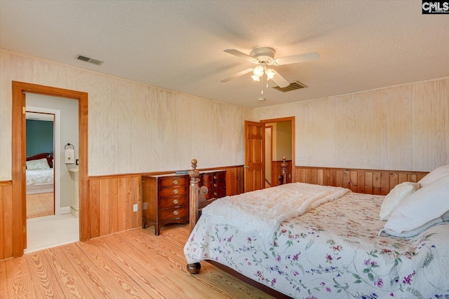 518 Pioneer Shores Rd, Prosperity, SC 29127 - bedroom featuring wood finished floors, a wainscoted wall, a textured ceiling, wooden walls, and a ceiling fan