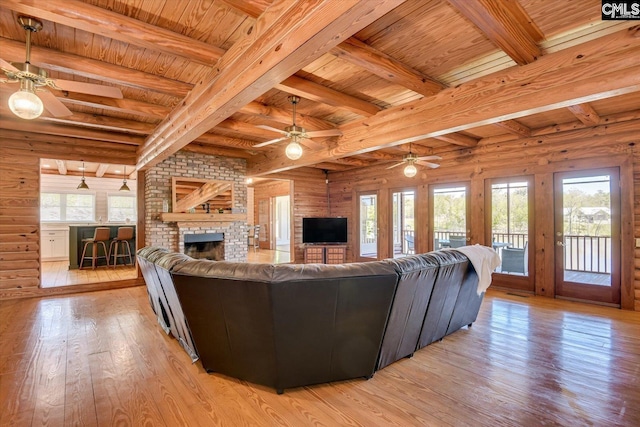 518 Pioneer Shores Rd, Prosperity, SC 29127 - living area with ceiling fan, light wood-style floors, plenty of natural light, a wood ceiling with exposed beams, and log walls