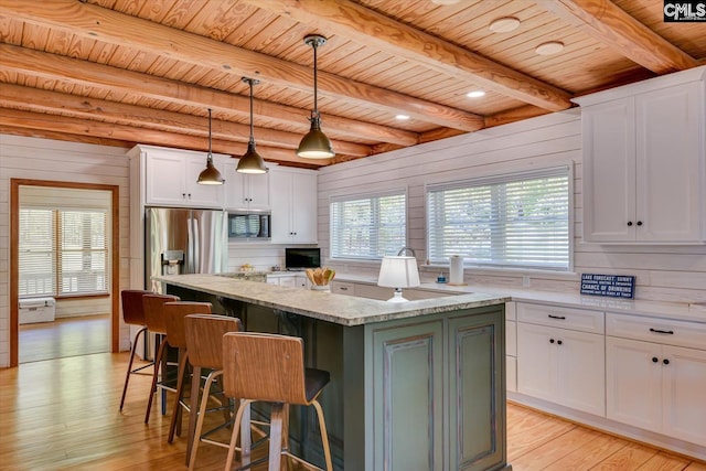518 Pioneer Shores Rd, Prosperity, SC 29127 - kitchen featuring appliances with stainless steel finishes, a wooden ceiling with exposed beams, a kitchen island, white cabinets, and light wood-style flooring
