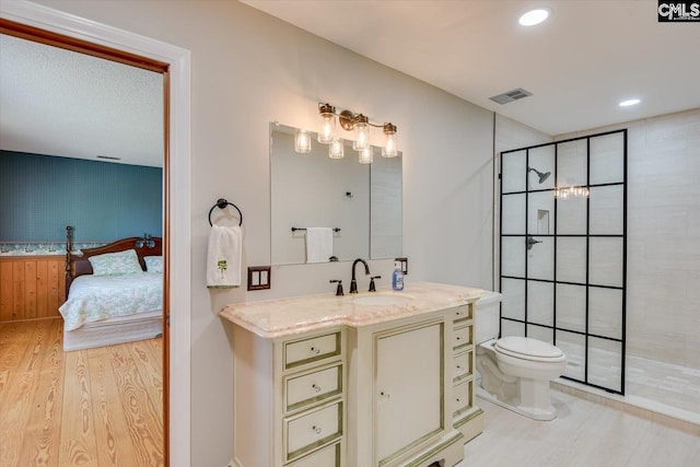 518 Pioneer Shores Rd, Prosperity, SC 29127 - full bath with connected bathroom, a tile shower, vanity, wood finished floors, and recessed lighting