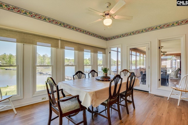 518 Pioneer Shores Rd, Prosperity, SC 29127 - dining area with a water view, light wood finished floors, healthy amount of natural light, and a ceiling fan