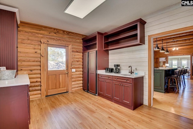 518 Pioneer Shores Rd, Prosperity, SC 29127 - kitchen with open shelves, light wood-style floors, light countertops, and rustic walls