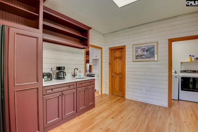 518 Pioneer Shores Rd, Prosperity, SC 29127 - bar featuring washing machine and clothes dryer, light wood finished floors, and wood walls