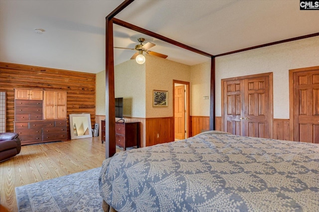 518 Pioneer Shores Rd, Prosperity, SC 29127 - bedroom with a wainscoted wall, wood finished floors, wood walls, vaulted ceiling, and ceiling fan