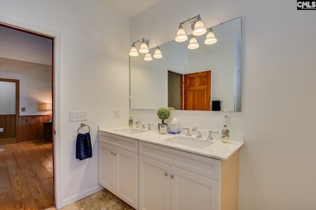 518 Pioneer Shores Rd, Prosperity, SC 29127 - bathroom with double vanity, a wainscoted wall, and wood finished floors