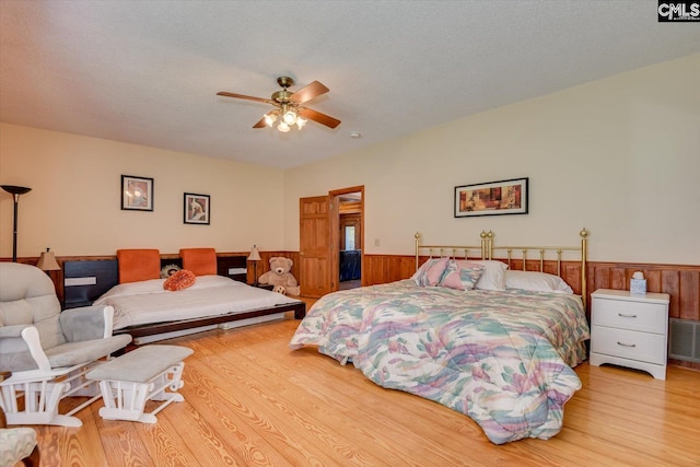 518 Pioneer Shores Rd, Prosperity, SC 29127 - bedroom with wood finished floors, a wainscoted wall, wood walls, and ceiling fan