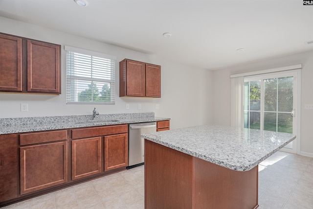 939 Sequoia Dr, Lexington, SC 29073 - kitchen featuring dishwasher, light stone countertops, a kitchen island, and light tile patterned floors