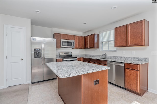 939 Sequoia Dr, Lexington, SC 29073 - kitchen featuring stainless steel appliances, a center island, light stone countertops, recessed lighting, and light tile patterned floors