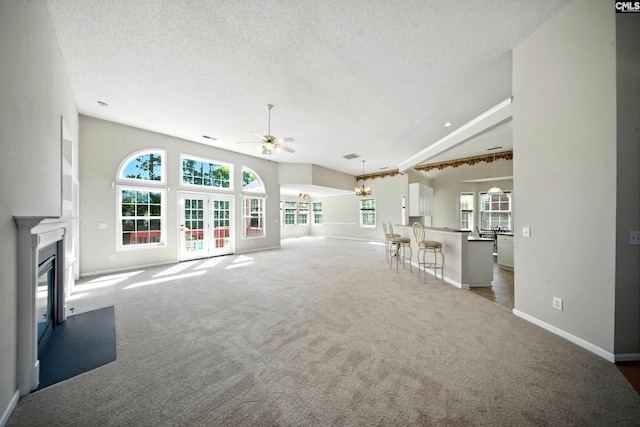 216 Founders Ridge Rd, Columbia, SC 29229 - unfurnished living room with a ceiling fan, a glass covered fireplace, carpet flooring, a textured ceiling, and a chandelier