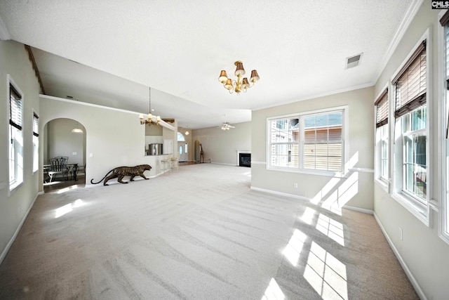 216 Founders Ridge Rd, Columbia, SC 29229 - carpeted living room with a chandelier, a fireplace, arched walkways, and crown molding