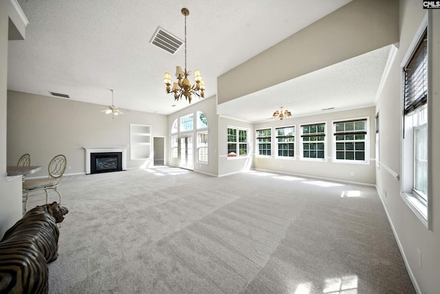 216 Founders Ridge Rd, Columbia, SC 29229 - unfurnished living room with a chandelier, a glass covered fireplace, ceiling fan, carpet, and a textured ceiling