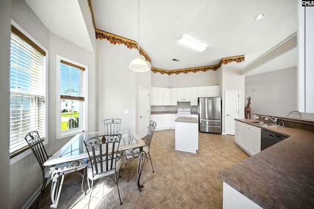 216 Founders Ridge Rd, Columbia, SC 29229 - kitchen with freestanding refrigerator, black dishwasher, plenty of natural light, a high ceiling, and a center island
