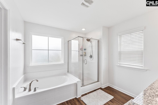 823 Queenshire Ln, Elgin, SC 29045 - bathroom with a bath, a shower stall, and wood finished floors