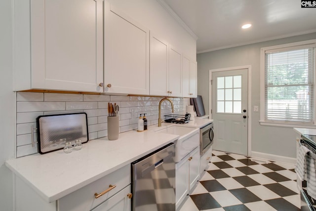 335-337 S Woodrow St, Columbia, SC 29205 - kitchen featuring stainless steel appliances, light floors, decorative backsplash, white cabinets, and crown molding