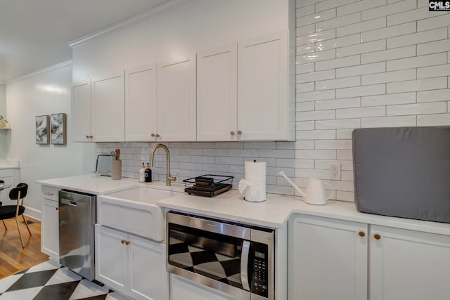 335-337 S Woodrow St, Columbia, SC 29205 - kitchen with appliances with stainless steel finishes, crown molding, backsplash, and white cabinets