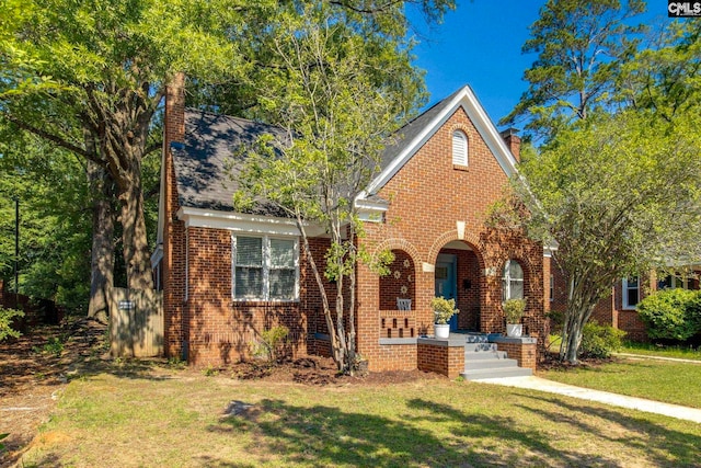 335-337 S Woodrow St, Columbia, SC 29205 - traditional home with brick siding, a chimney, and a front yard
