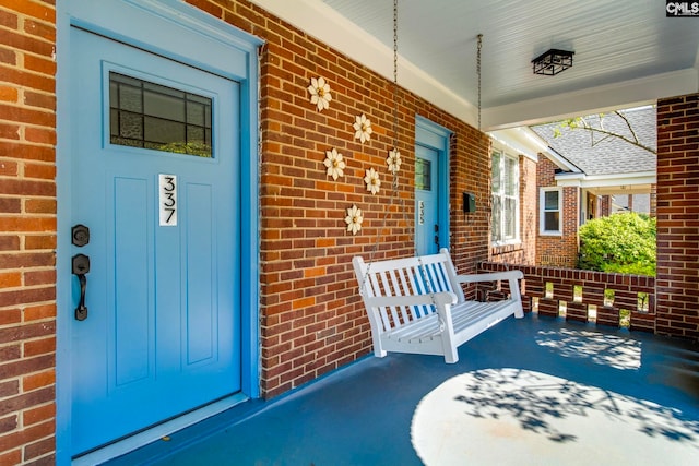 335-337 S Woodrow St, Columbia, SC 29205 - doorway to property featuring covered porch and brick siding
