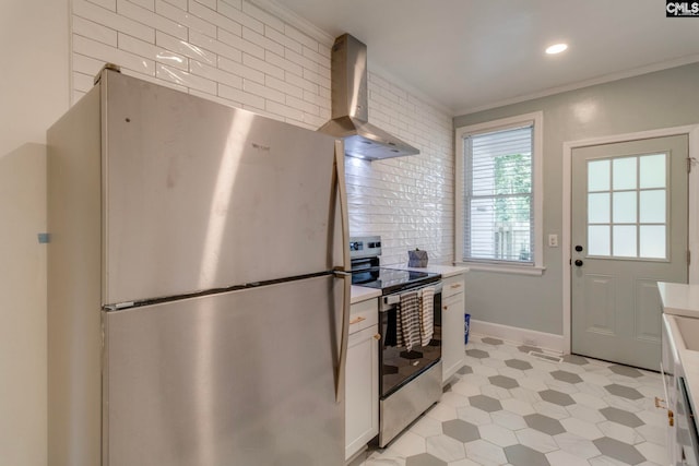 335-337 S Woodrow St, Columbia, SC 29205 - kitchen with appliances with stainless steel finishes, wall chimney range hood, crown molding, light floors, and light countertops