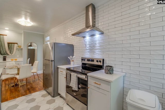 335-337 S Woodrow St, Columbia, SC 29205 - kitchen with appliances with stainless steel finishes, wall chimney exhaust hood, light countertops, ornamental molding, and light tile patterned flooring