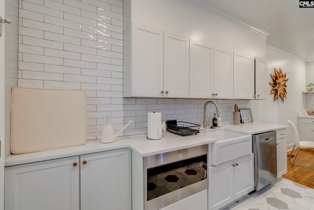 335-337 S Woodrow St, Columbia, SC 29205 - kitchen with stainless steel appliances, ornamental molding, backsplash, and white cabinets