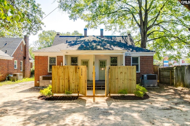 335-337 S Woodrow St, Columbia, SC 29205 - rear view of house featuring brick siding, a chimney, a deck, and roof with shingles