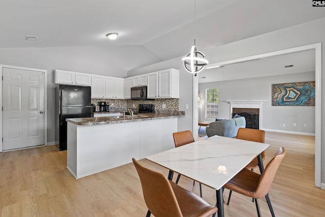 3 Fonthill Ct, Columbia, SC 29229 - dining space featuring vaulted ceiling, light wood-style floors, and a fireplace
