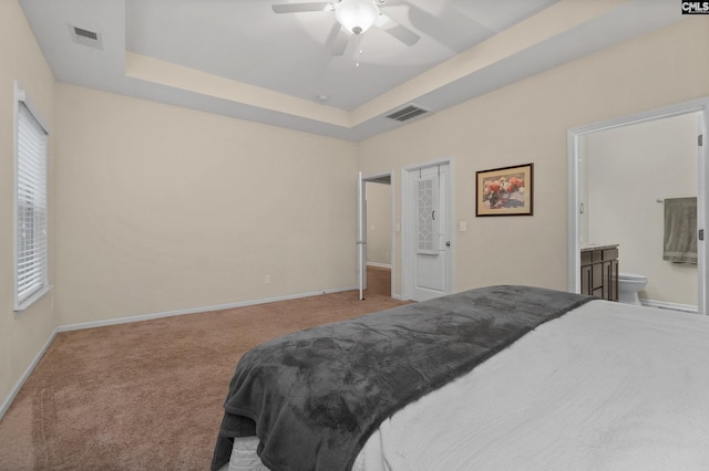 6 Genessee Ct, Irmo, SC 29063 - carpeted bedroom featuring a raised ceiling, ensuite bathroom, and ceiling fan