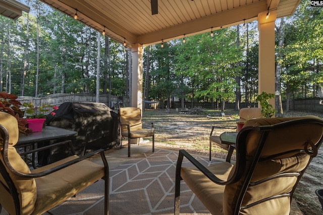 6 Genessee Ct, Irmo, SC 29063 - fenced backyard with ceiling fan, view of scattered trees, and a patio area