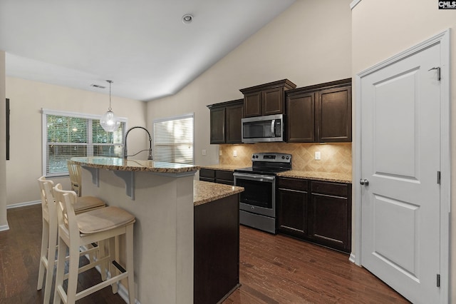 6 Genessee Ct, Irmo, SC 29063 - kitchen with stainless steel appliances, light stone countertops, backsplash, a kitchen breakfast bar, and dark wood finished floors