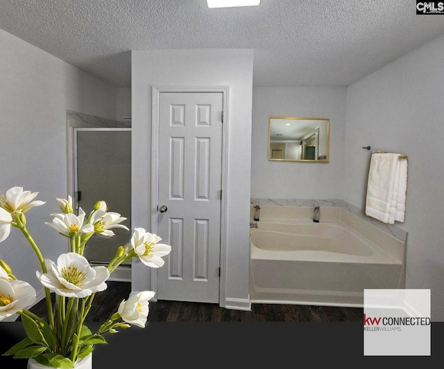 11 Long Glen Ct, Columbia, SC 29229 - bathroom with a garden tub, a textured ceiling, a shower stall, and wood finished floors