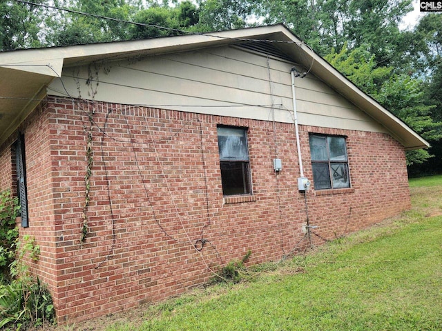 110 Quattlebaum Ave, Ridge Spring, SC 29129 - view of property exterior with a yard and brick siding
