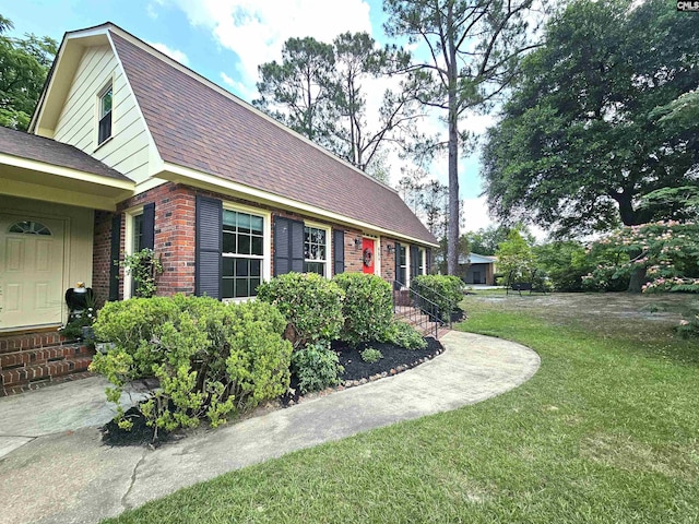 904 Sunnyhill Dr, Camden, SC 29020 - view of property exterior with a lawn, brick siding, and roof with shingles