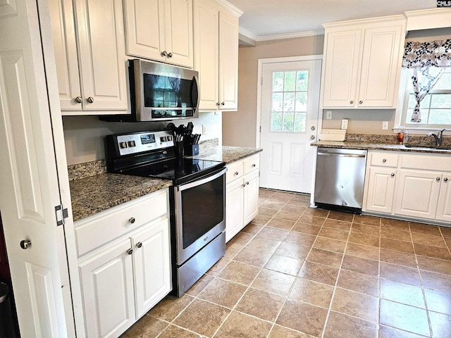 904 Sunnyhill Dr, Camden, SC 29020 - kitchen featuring appliances with stainless steel finishes, ornamental molding, white cabinets, and dark stone counters