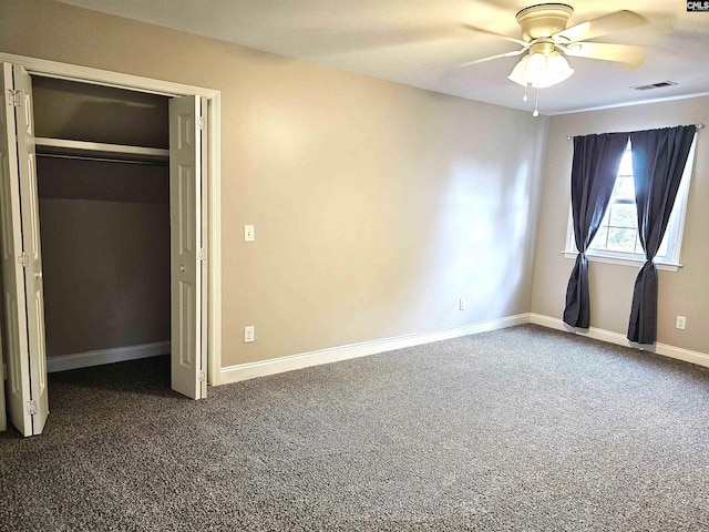 904 Sunnyhill Dr, Camden, SC 29020 - unfurnished bedroom featuring dark carpet, a closet, and a ceiling fan