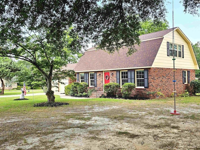 904 Sunnyhill Dr, Camden, SC 29020 - colonial inspired home featuring a gambrel roof, brick siding, a front lawn, and roof with shingles