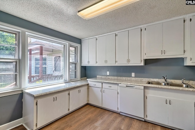 914 Hook Ave, West Columbia, SC 29169 - kitchen with dishwasher, light countertops, light wood-type flooring, a textured ceiling, and white cabinetry