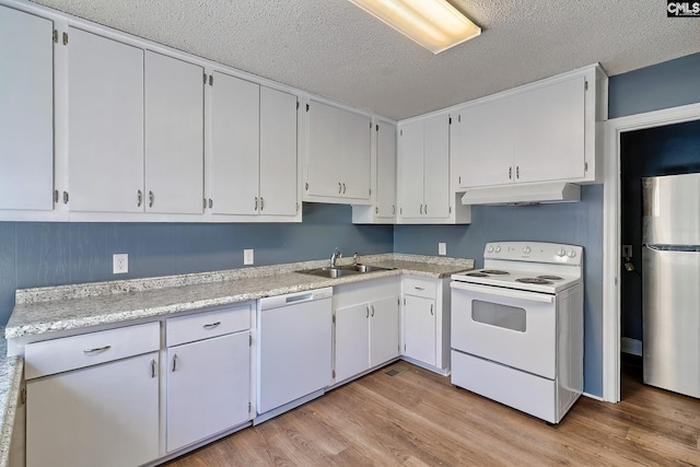 914 Hook Ave, West Columbia, SC 29169 - kitchen featuring white appliances, under cabinet range hood, light wood-type flooring, a textured ceiling, and light countertops